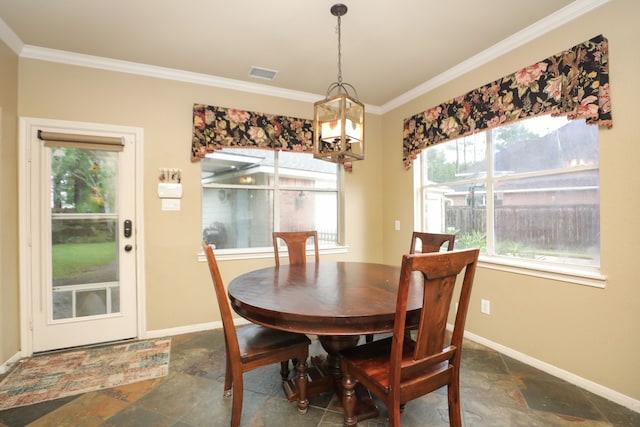 14310 Saint Pierre Ln, Cypress, TX 77429 - dining area featuring stone tile floors, crown molding, and a chandelier