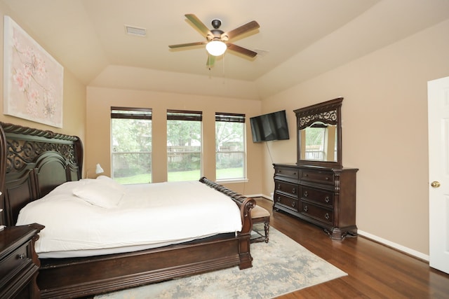 14310 Saint Pierre Ln, Cypress, TX 77429 - bedroom with a tray ceiling, dark wood-style flooring, and a ceiling fan