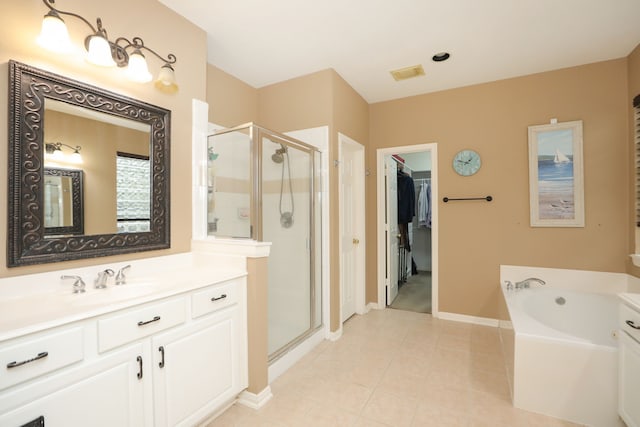 14310 Saint Pierre Ln, Cypress, TX 77429 - bathroom with a stall shower, a bath, vanity, a walk in closet, and tile patterned floors
