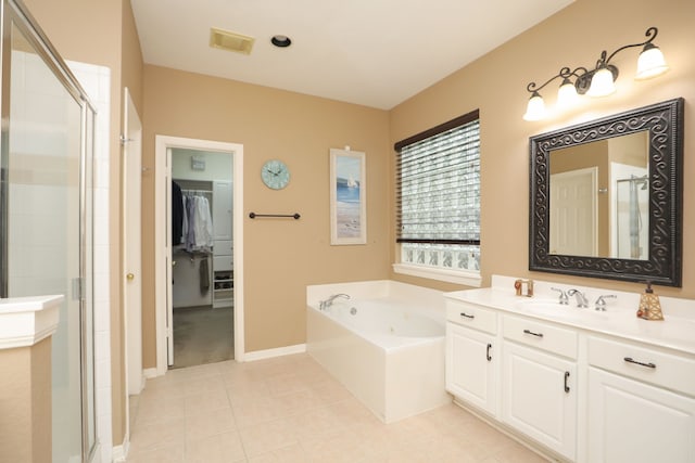 14310 Saint Pierre Ln, Cypress, TX 77429 - full bathroom with a stall shower, vanity, tile patterned flooring, a walk in closet, and a tub with jets