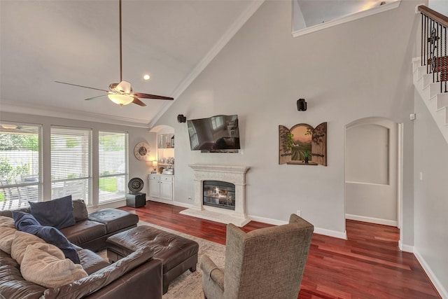 16407 Torry View Ter, Houston, TX 77095 - living room with high vaulted ceiling, crown molding, a glass covered fireplace, wood finished floors, and a ceiling fan