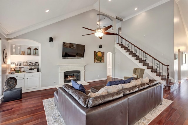16407 Torry View Ter, Houston, TX 77095 - living room with stairway, a ceiling fan, a glass covered fireplace, dark wood-style floors, and high vaulted ceiling
