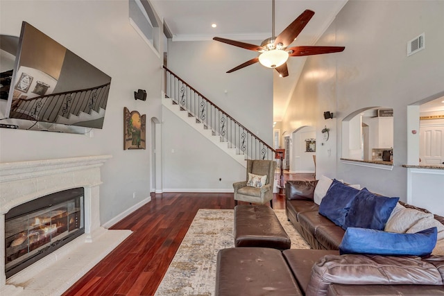 16407 Torry View Ter, Houston, TX 77095 - living area with stairs, a high ceiling, a ceiling fan, wood finished floors, and a glass covered fireplace