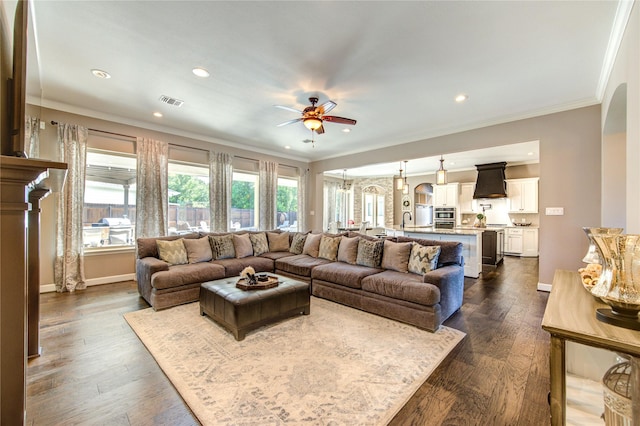 6506 Camillia Ct, Katy, TX 77493 - living area featuring ornamental molding, ceiling fan, recessed lighting, dark wood-type flooring, and arched walkways