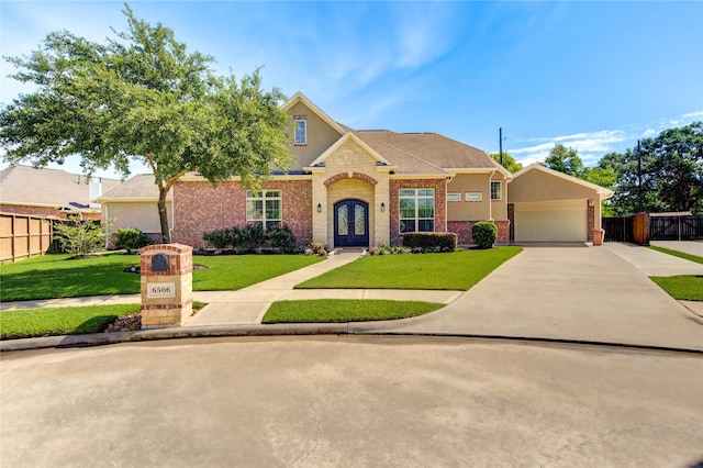 6506 Camillia Ct, Katy, TX 77493 - traditional-style house with french doors, concrete driveway, a garage, stucco siding, and brick siding