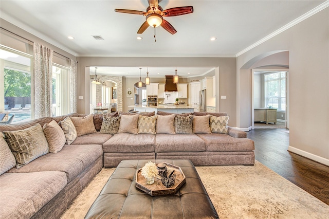 6506 Camillia Ct, Katy, TX 77493 - living area featuring arched walkways, ornamental molding, ceiling fan, wood finished floors, and recessed lighting