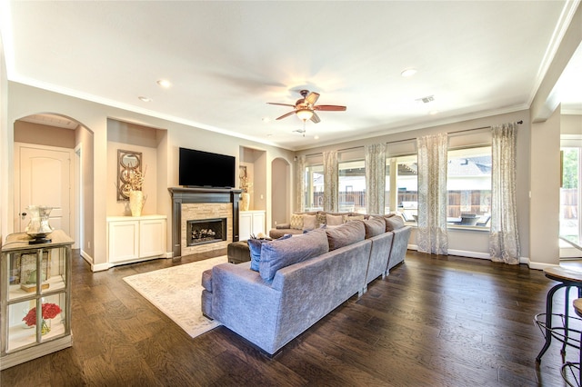 6506 Camillia Ct, Katy, TX 77493 - living area featuring arched walkways, ornamental molding, ceiling fan, a stone fireplace, and recessed lighting