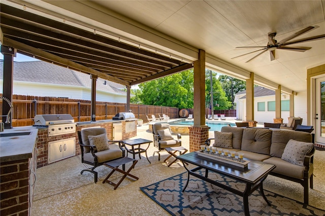 6506 Camillia Ct, Katy, TX 77493 - fenced backyard with exterior kitchen, an outdoor hangout area, ceiling fan, and a patio