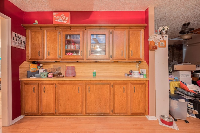16318 Spinnaker Dr, Crosby, TX 77532 - bar area featuring light wood-style flooring and a textured ceiling