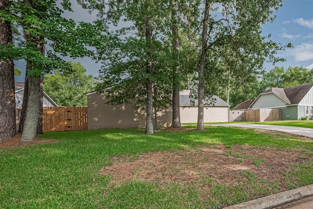 16318 Spinnaker Dr, Crosby, TX 77532 - view of yard featuring concrete driveway and a gate