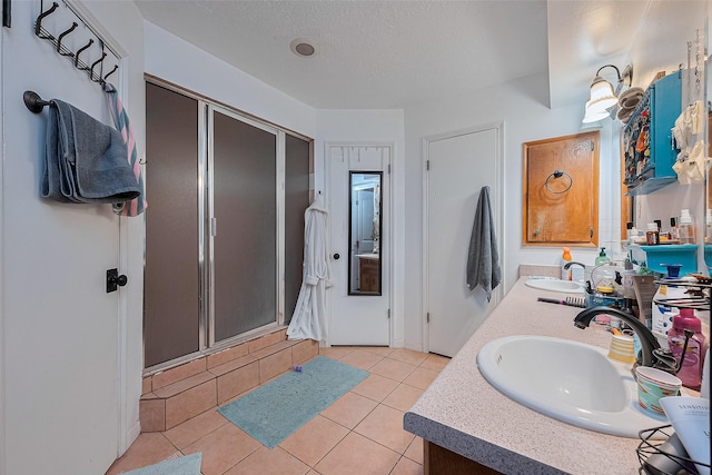 16318 Spinnaker Dr, Crosby, TX 77532 - full bath featuring a shower stall, double vanity, tile patterned floors, and a textured ceiling