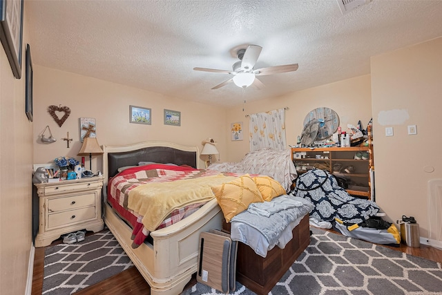 16318 Spinnaker Dr, Crosby, TX 77532 - bedroom with wood finished floors, a textured ceiling, and a ceiling fan