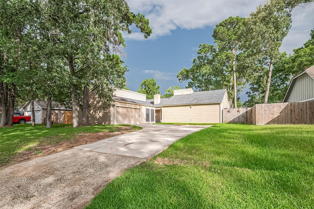 16318 Spinnaker Dr, Crosby, TX 77532 - view of front of house featuring driveway, an attached garage, and a chimney