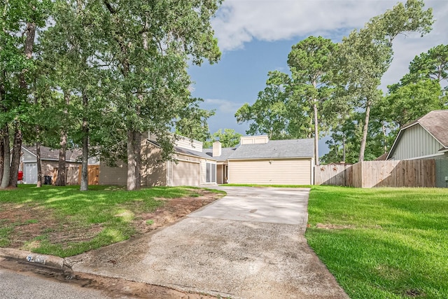 16318 Spinnaker Dr, Crosby, TX 77532 - view of front facade featuring driveway, brick siding, a garage, and a chimney