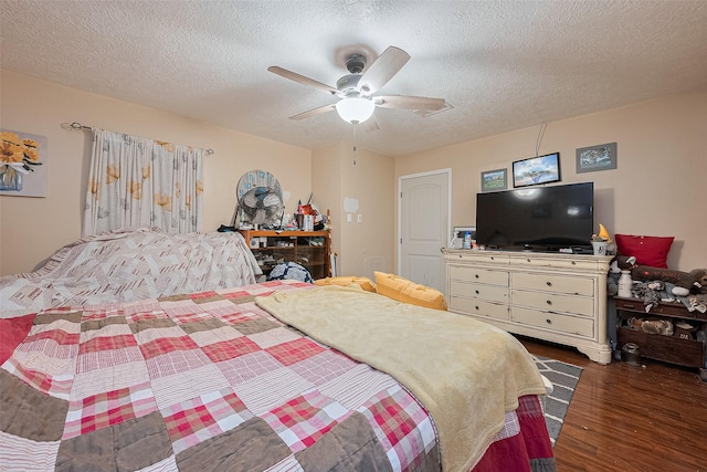 16318 Spinnaker Dr, Crosby, TX 77532 - bedroom with dark wood-style flooring, a textured ceiling, and a ceiling fan