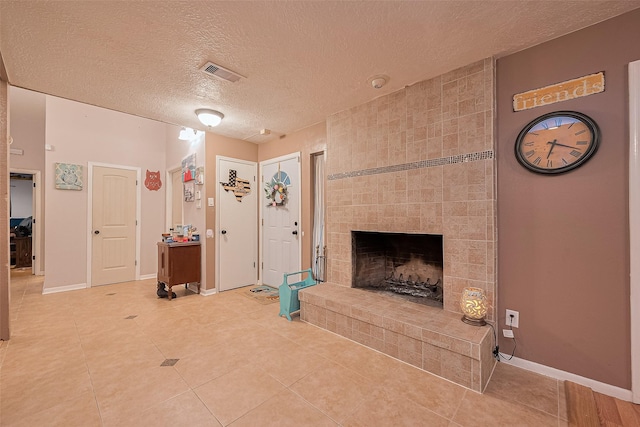 16318 Spinnaker Dr, Crosby, TX 77532 - unfurnished living room featuring a textured ceiling, a fireplace, and light tile patterned floors