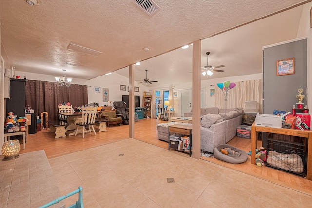 16318 Spinnaker Dr, Crosby, TX 77532 - tiled living room with a ceiling fan, a textured ceiling, a chandelier, and vaulted ceiling