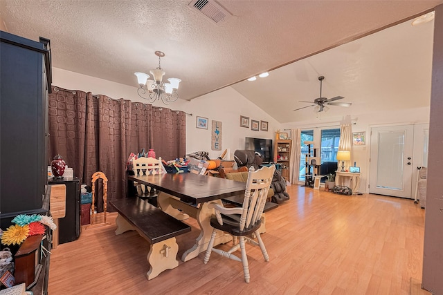 16318 Spinnaker Dr, Crosby, TX 77532 - dining room featuring a chandelier, light wood-type flooring, lofted ceiling, a textured ceiling, and ceiling fan