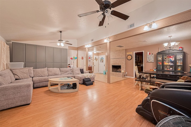 16318 Spinnaker Dr, Crosby, TX 77532 - living area featuring a ceiling fan, wood finished floors, lofted ceiling, a chandelier, and a tile fireplace