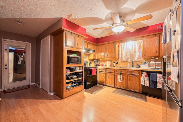 16318 Spinnaker Dr, Crosby, TX 77532 - kitchen with black microwave, stove, dishwashing machine, brown cabinets, and light wood finished floors