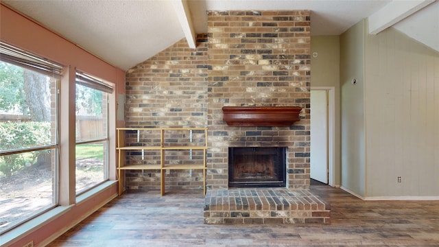 1116 N Bristol Ct, League City, TX 77573 - unfurnished living room featuring wood finished floors, a brick fireplace, and wooden walls