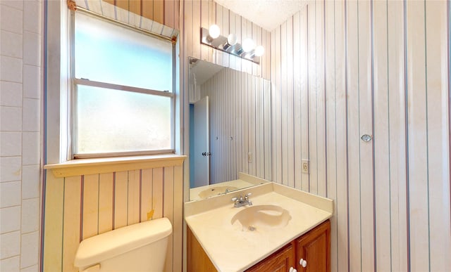 1116 N Bristol Ct, League City, TX 77573 - bathroom with vanity, wood walls, and wallpapered walls