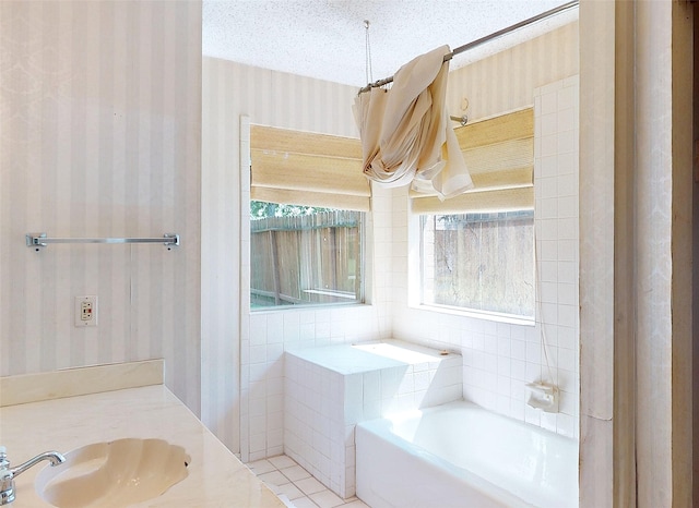1116 N Bristol Ct, League City, TX 77573 - full bath with wallpapered walls, a garden tub, vanity, and a textured ceiling