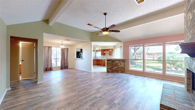 1116 N Bristol Ct, League City, TX 77573 - unfurnished living room with a fireplace, wood finished floors, a ceiling fan, a textured ceiling, and healthy amount of natural light