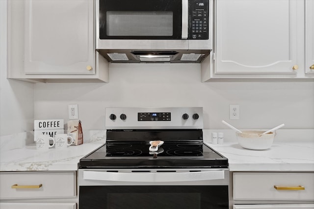 4519 Pineville Ln, Spring, TX 77388 - kitchen featuring electric stove, stainless steel microwave, and white cabinets