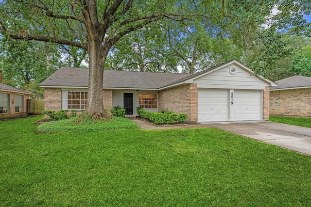 4519 Pineville Ln, Spring, TX 77388 - view of front of home featuring brick siding, a garage, concrete driveway, and a front lawn
