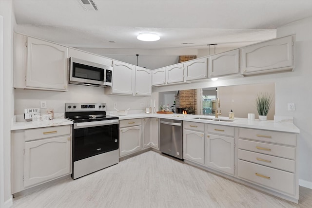 4519 Pineville Ln, Spring, TX 77388 - kitchen featuring appliances with stainless steel finishes, light wood-style flooring, and light countertops