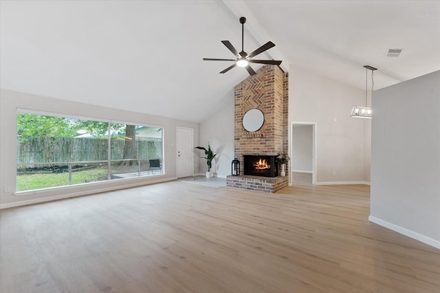 4519 Pineville Ln, Spring, TX 77388 - unfurnished living room featuring high vaulted ceiling, ceiling fan, beam ceiling, light wood-style floors, and a fireplace