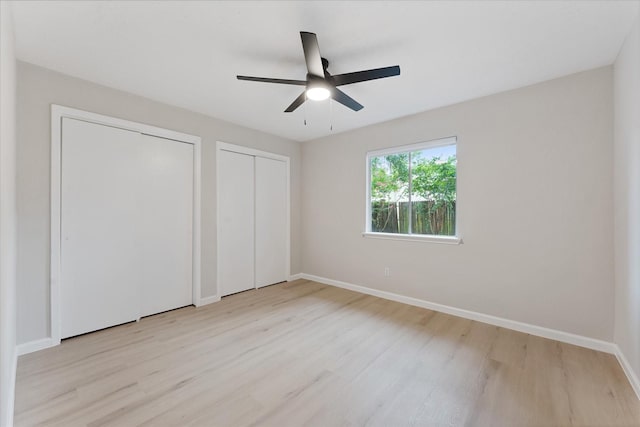 4519 Pineville Ln, Spring, TX 77388 - unfurnished bedroom with wood finished floors, multiple closets, and ceiling fan