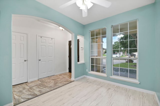 8207 Miramar Crest Ct, Tomball, TX 77375 - unfurnished room featuring arched walkways, ceiling fan, and wood finished floors
