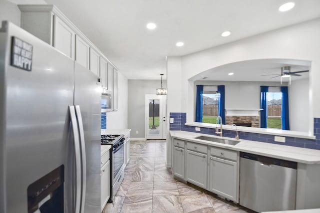 8207 Miramar Crest Ct, Tomball, TX 77375 - kitchen featuring appliances with stainless steel finishes, light marble finish flooring, recessed lighting, ceiling fan, and backsplash