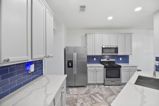 8207 Miramar Crest Ct, Tomball, TX 77375 - kitchen with stainless steel appliances, tasteful backsplash, light marble finish flooring, light stone countertops, and recessed lighting