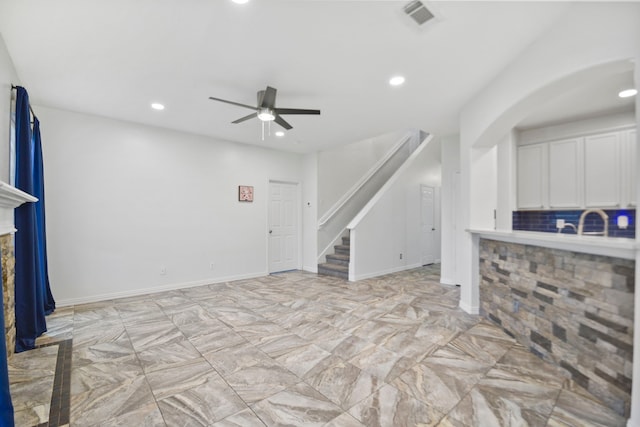 8207 Miramar Crest Ct, Tomball, TX 77375 - unfurnished living room featuring stairs, recessed lighting, ceiling fan, light marble finish flooring, and arched walkways