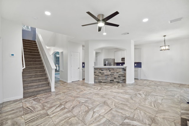 8207 Miramar Crest Ct, Tomball, TX 77375 - unfurnished living room with arched walkways, ceiling fan, stairs, and recessed lighting