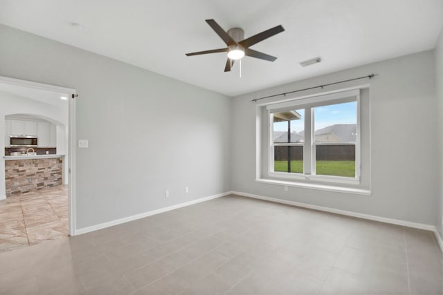 8207 Miramar Crest Ct, Tomball, TX 77375 - unfurnished room featuring a ceiling fan and arched walkways