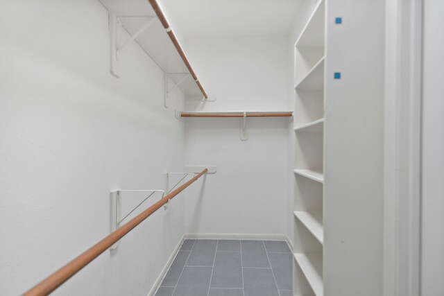 8207 Miramar Crest Ct, Tomball, TX 77375 - spacious closet with dark tile patterned flooring