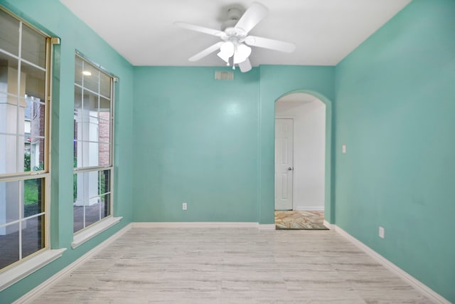 8207 Miramar Crest Ct, Tomball, TX 77375 - spare room with arched walkways, wood finished floors, and ceiling fan