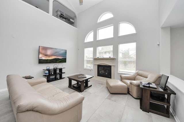 13710 Breezy Meadow Ct, Houston, TX 77044 - tiled living area with plenty of natural light, a high ceiling, and a glass covered fireplace