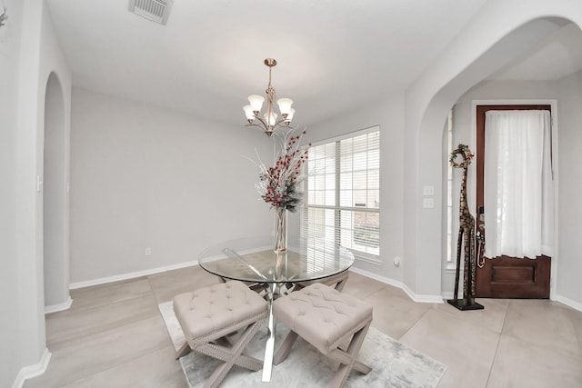 13710 Breezy Meadow Ct, Houston, TX 77044 - dining area featuring arched walkways, light tile patterned floors, and a chandelier