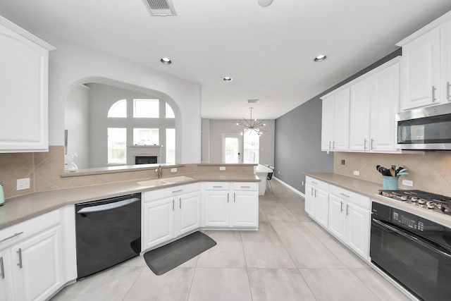 13710 Breezy Meadow Ct, Houston, TX 77044 - kitchen with appliances with stainless steel finishes, a chandelier, recessed lighting, light countertops, and white cabinets