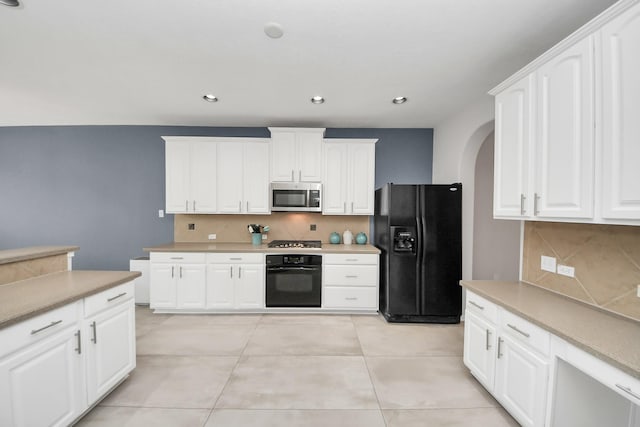 13710 Breezy Meadow Ct, Houston, TX 77044 - kitchen featuring black appliances, arched walkways, decorative backsplash, light countertops, and white cabinets