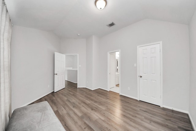 13710 Breezy Meadow Ct, Houston, TX 77044 - unfurnished bedroom with lofted ceiling, wood finished floors, and connected bathroom