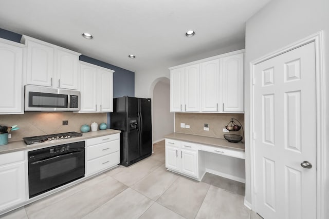 13710 Breezy Meadow Ct, Houston, TX 77044 - kitchen featuring black appliances, arched walkways, white cabinets, decorative backsplash, and light countertops