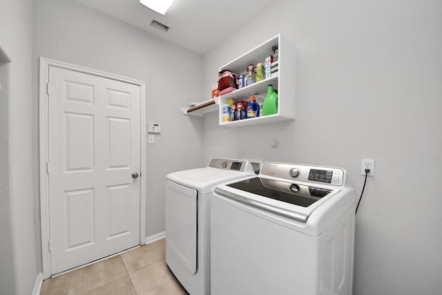 13710 Breezy Meadow Ct, Houston, TX 77044 - laundry area featuring washing machine and dryer and light tile patterned flooring