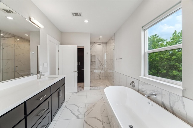 919 W 16th St Unit C, Houston, TX 77008 - bathroom with marble finish floors, a marble finish shower, a freestanding bath, vanity, and recessed lighting