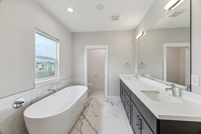 919 W 16th St Unit C, Houston, TX 77008 - bathroom featuring marble finish flooring, double vanity, a freestanding tub, and recessed lighting